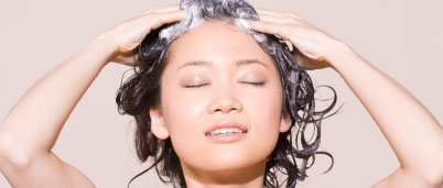 A woman shampooing her hair