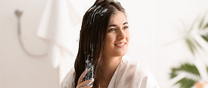 A woman conditioning her hair