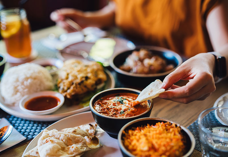 Dipping bread into tasy dishes