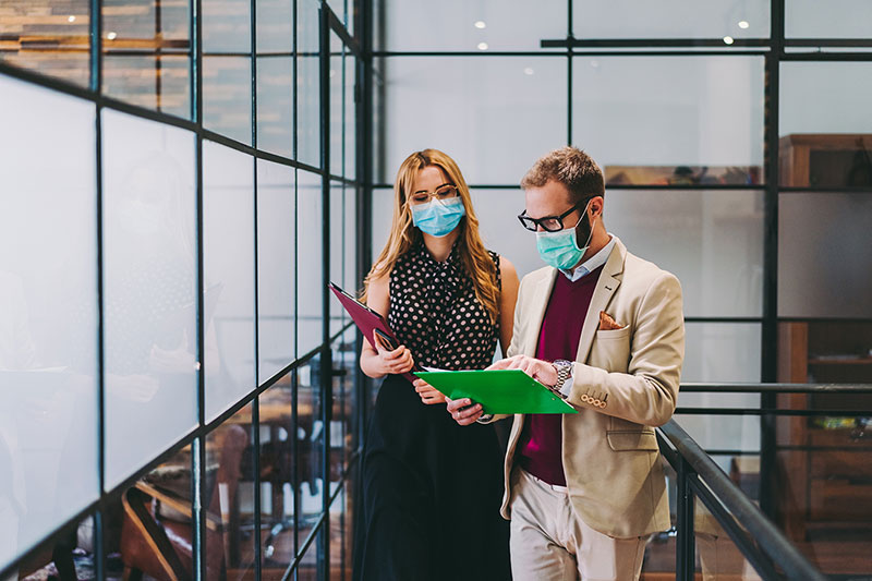Two people holding clipboards in the lobby
