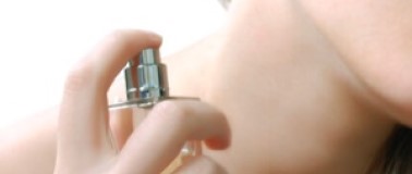 img title Woman applying perfume
