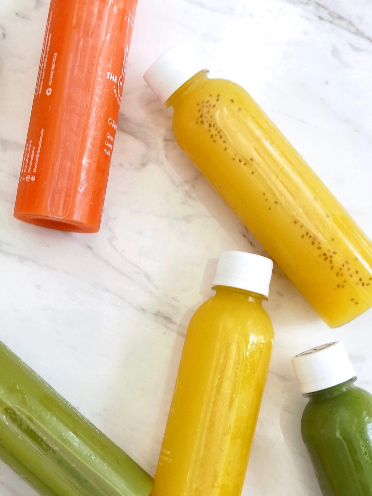Assortment of bottled vegetable juices on a table