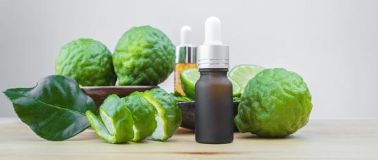 Bergamot fruit on a table with essential oil bottle