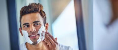 Man rubbing shaving foam on his face