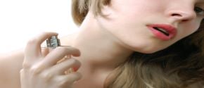 img title Woman applying perfume
